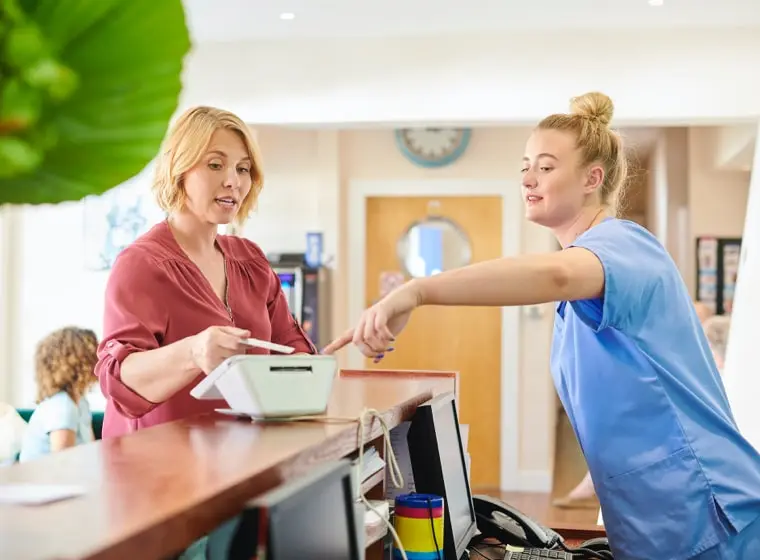 nurse using patient payment solutions from Datalink to help process a patient's payment